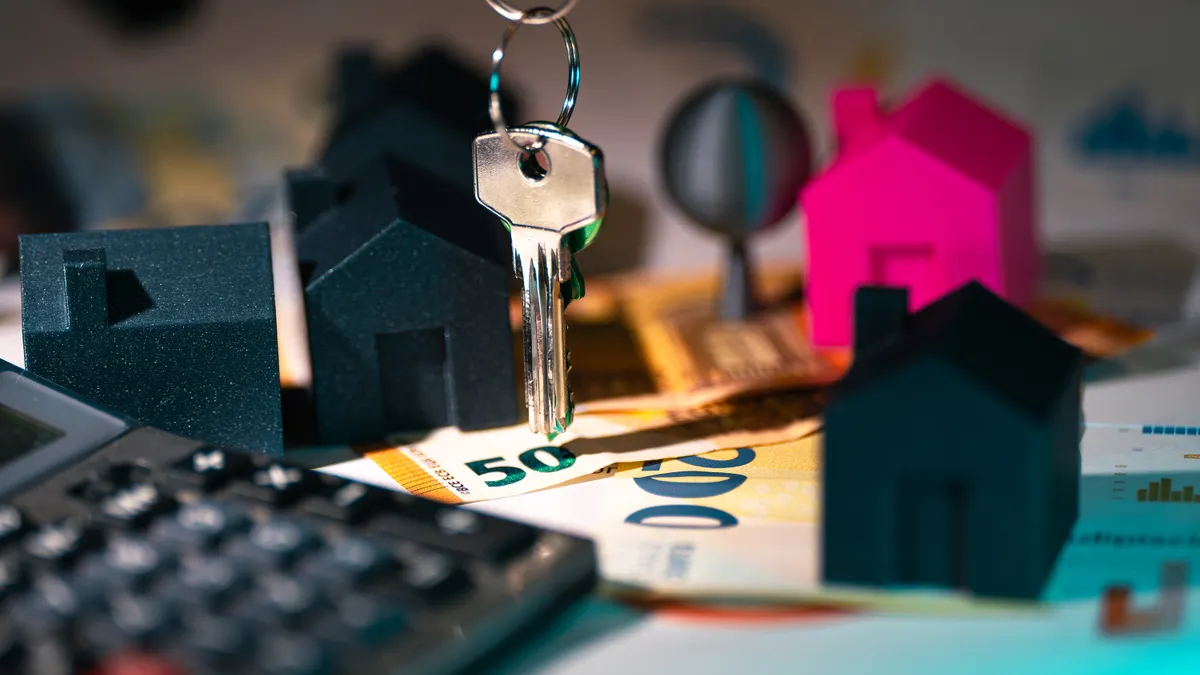 How to Choose the Best Listing Price Strategy House key over model homes and a chart