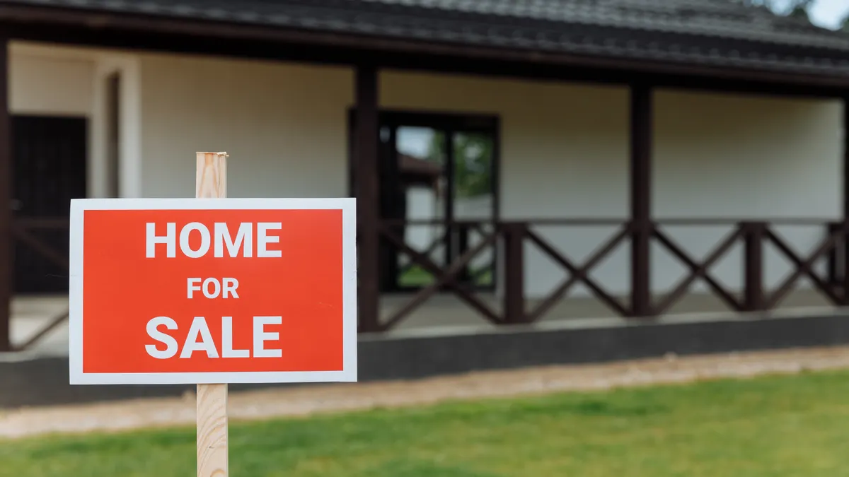 Home for sale sign outside a house