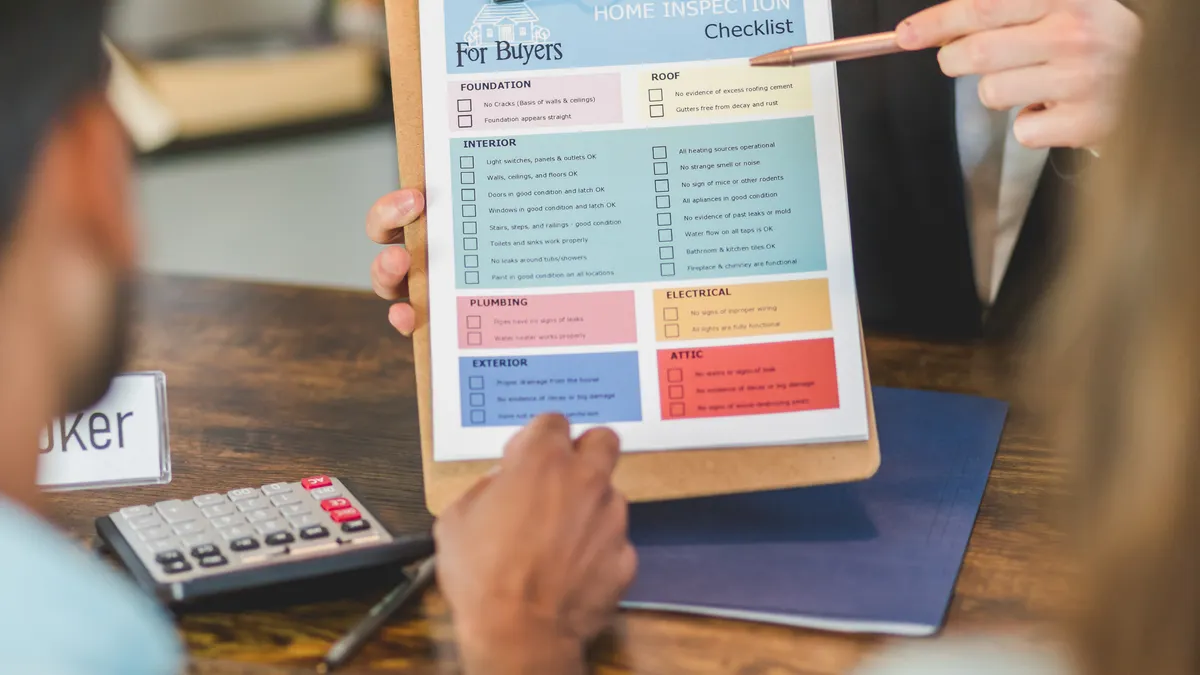 Home inspection checklist being reviewed on a clipboard