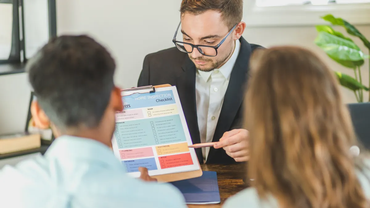 Agent reviewing a checklist with buyers at a table
